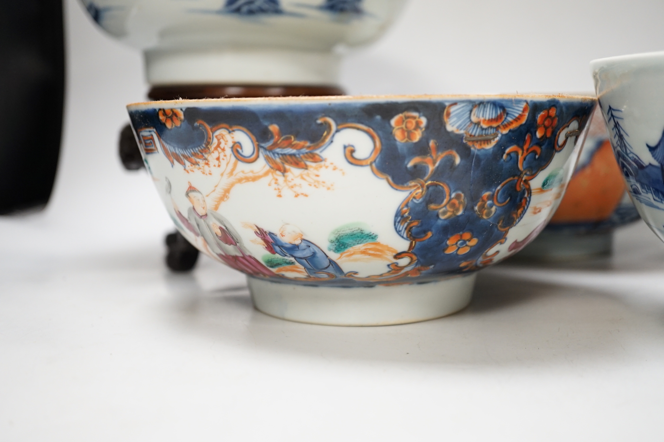Four 18th century Chinese porcelain bowls (a.f), one with hardwood stand, largest 28cm diameter